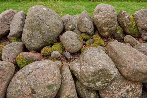 Closeup of a stone wall made of boulders and rocks outside. Background of rustic, rural building and masonry material. Historic housing design or antique architecture of an urban structure outdoors. - Valokuva, kuva
