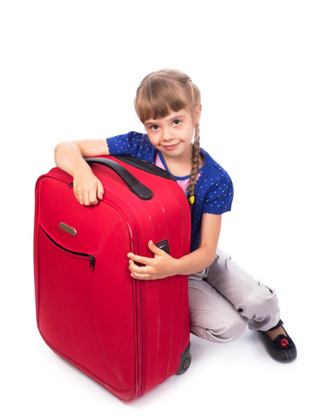 girl and big red suitcase isolated on white background - Foto, Bild