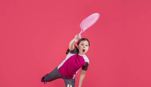 kid playe tennis with racket on pink background. - Φωτογραφία, εικόνα