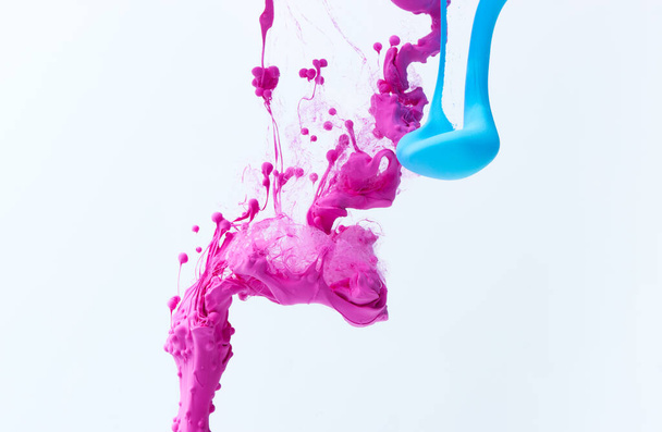Mixed ink dynamic abstract background with splash of acrylic paint in water. Flowing acrylic backdrop picture - Photo, image