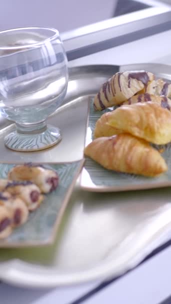 Chocolate bakery products called mini napolitana and croissants on a metal tray with coffee for breakfast. Sweet snack. - 映像、動画