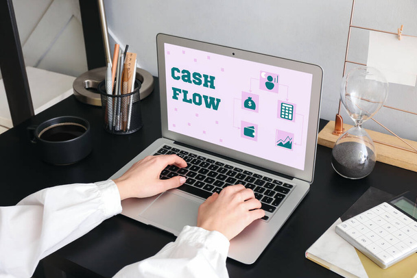 Woman working with modern laptop in office. Cash flow - Foto, Imagem