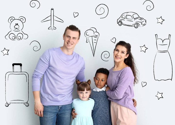 Happy young family dreaming about their future on light background - Foto, afbeelding