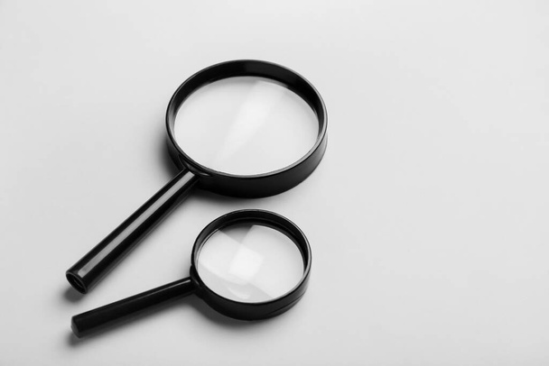 Magnifying glasses on light background - Foto, imagen