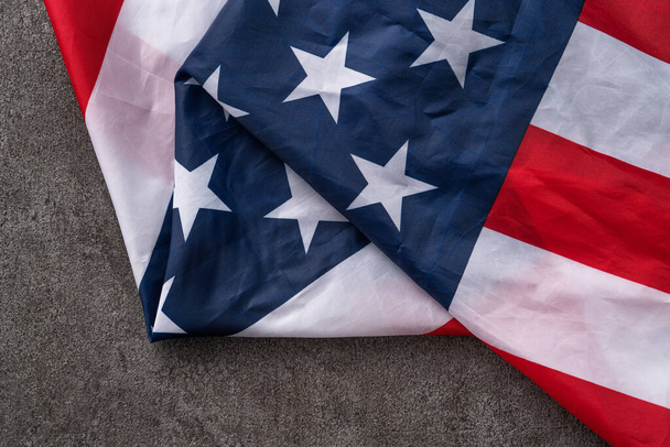 Concept of U.S Independence day or Memorial day. National flag over dark gray table background. - Fotoğraf, Görsel