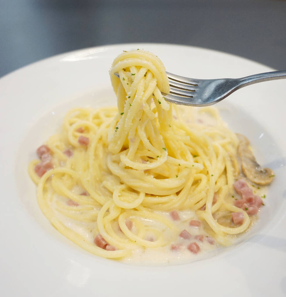 Spaghetti Carbonara Italian cuisine on white dish - Фото, изображение