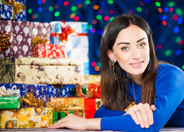 Cheerful brunet portrait at holiday gifts background - Photo, Image