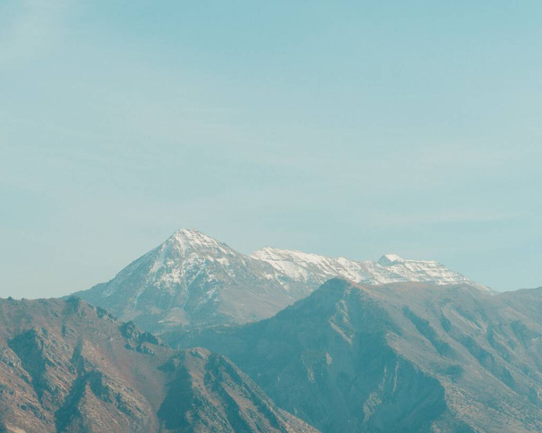 A landscape with mountain range against a blue sky - Zdjęcie, obraz
