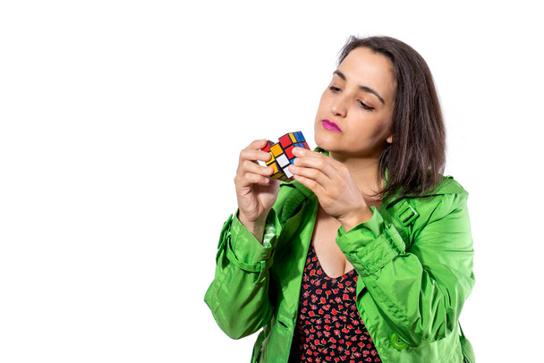young girl solving the Rubik's cube. Thinking concept - 写真・画像