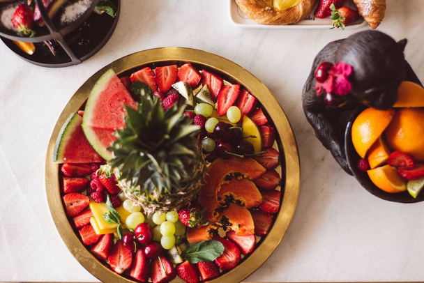 A top view of watermelon, strawberries, cherries, grapes, raspberries, grapes, pineapple, and kiwi - Φωτογραφία, εικόνα