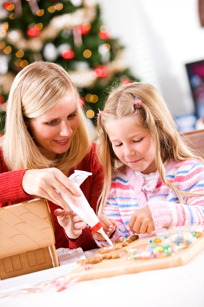 Christmas: Mother Helps Girl With Icing For Gingerbread Decorati - Photo, image