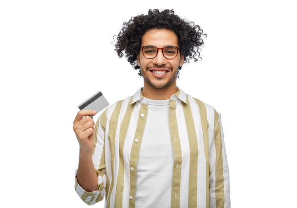 shopping, finance and people concept - happy smiling man with credit card over white background - Foto, Imagen