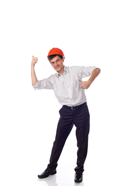Man in a shirt orange construction helmet, thumbs up isolate - Fotografie, Obrázek