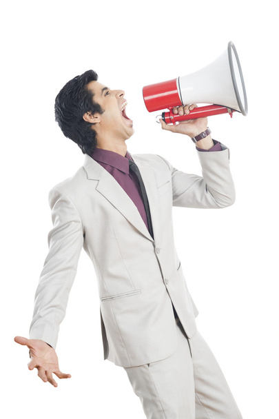 Businessman shouting into a megaphone - Foto, Imagen