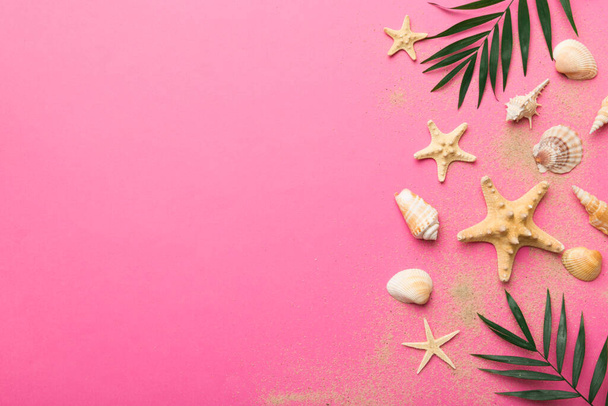 Summer time concept Flat lay composition with beautiful starfish and sea shells on colored table, top view with copy space for text. - Photo, Image