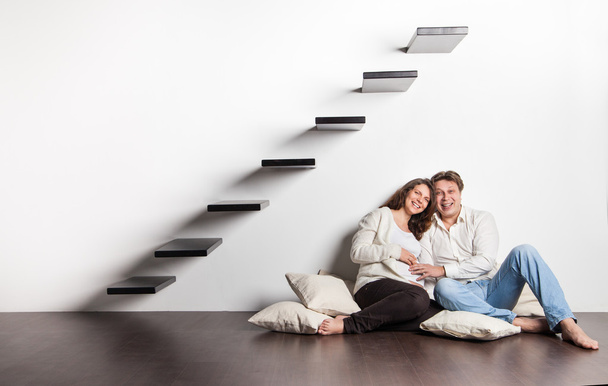 Couple at home sitting on stairs. Pregnancy - Valokuva, kuva