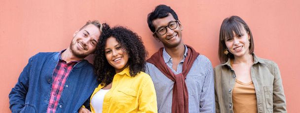 Horizontal banner or header with multiracial friends group having fun at wall on university college campus - Diverse culture students portrait celebrating outside - Foto, Bild
