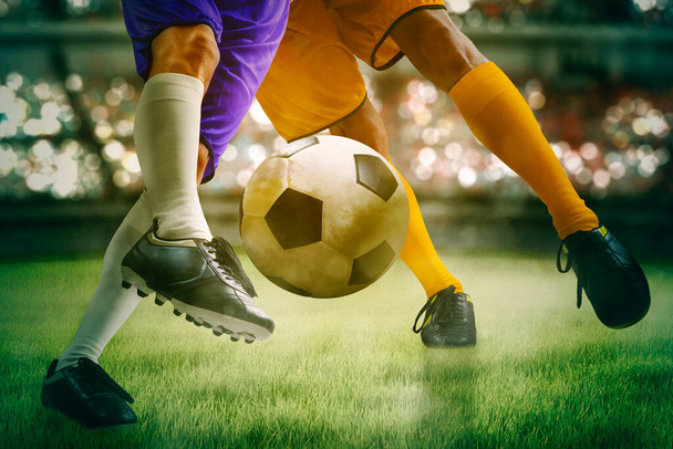 Close up of two soccer players feet competing on the soccer field while intense struggle for the ball - Photo, Image