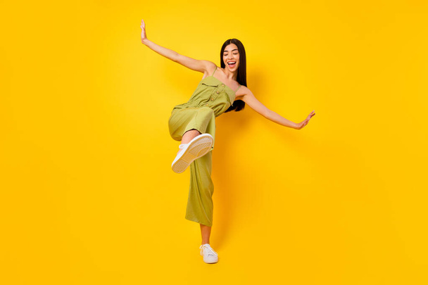 Full length photo of overjoyed cheerful vietnamese girl dance have good mood isolated on yellow color background. - Фото, зображення