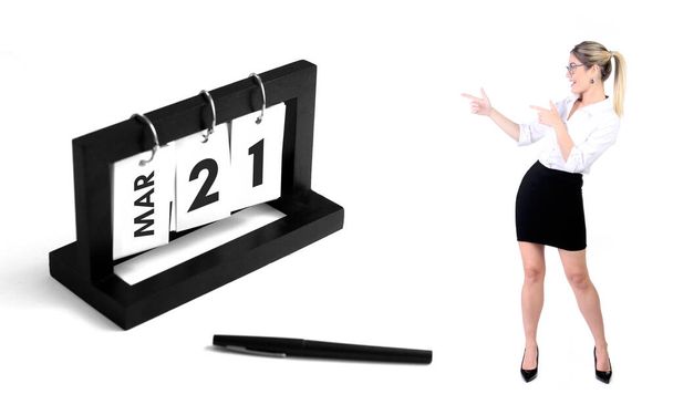 march 21 calendar for business, executives, entrepreneurs and anniversary. Business woman pointing to calendar. Birthday card message for print. - Fotó, kép