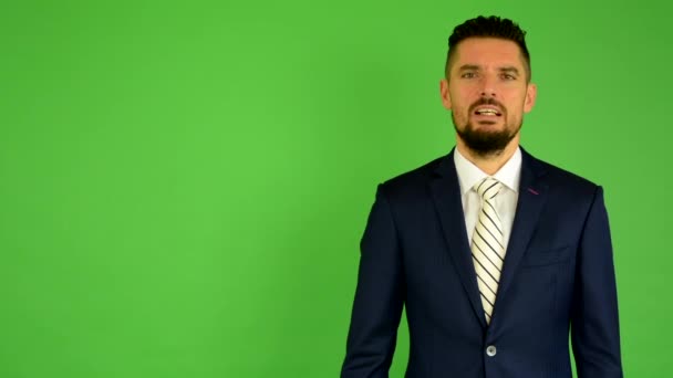Business man talks to camera (interview) - green screen - studio - Footage, Video
