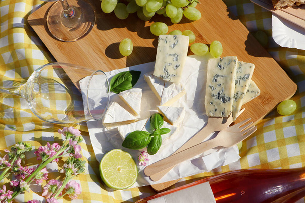 Delicious food and wine on picnic blanket, flat lay - 写真・画像