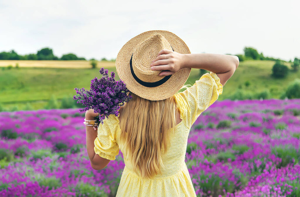 Beautiful woman in lavender field. Selective focus. Nature. - Fotografie, Obrázek