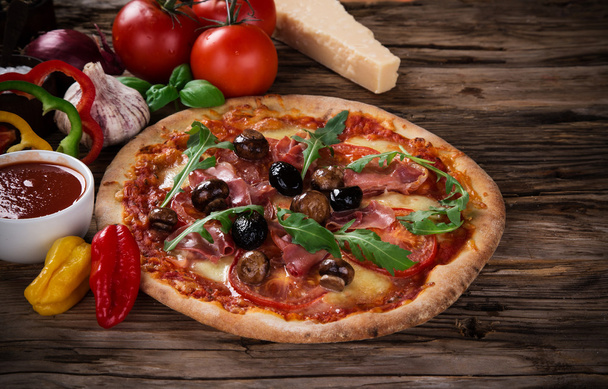 Delicious italian pizza served on wooden table - Zdjęcie, obraz
