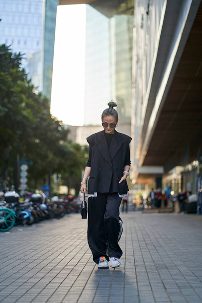 fashionable mid adult asian woman walking on street - Foto, immagini