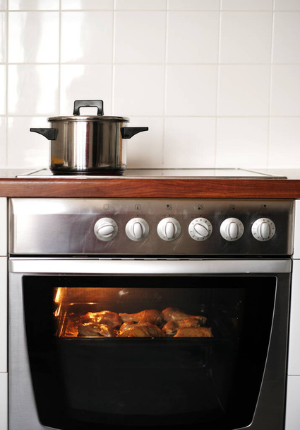metal pan on induction cooker in kitchen - Photo, Image