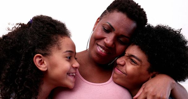 African mother embracing son and daughter. Mixed race mom hugging children - Φωτογραφία, εικόνα