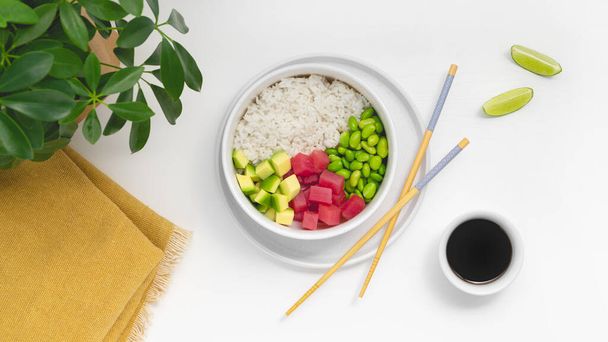 Hawaiian poke bowl with tuna, rice, edamame beans, tomato, lime and avocado. High quality photo - 写真・画像