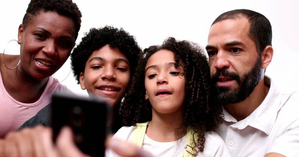 African descent family looking at cellphone together - Photo, image