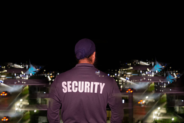 Security guard patrolling city streets at night - Foto, Imagem
