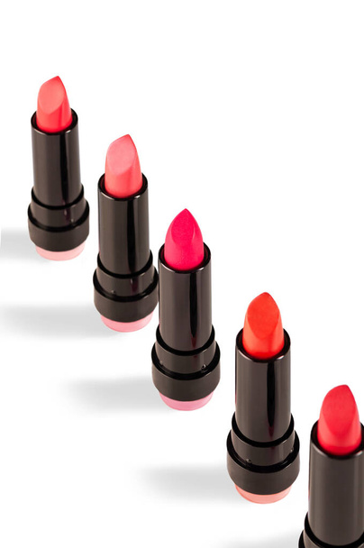 Different colors of lipstick on a white background. Decorative cosmetics. - Zdjęcie, obraz