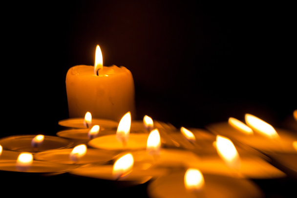 Candles cutting through the darkness - Foto, Bild