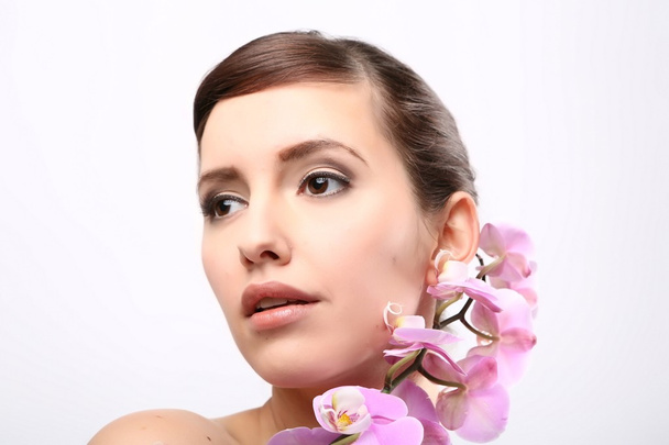 Beautiful Girl With Orchid Flowers. - Fotografie, Obrázek