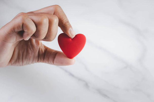 Hand holding a red heart. Romantic love concept. Copy space. - Fotografie, Obrázek