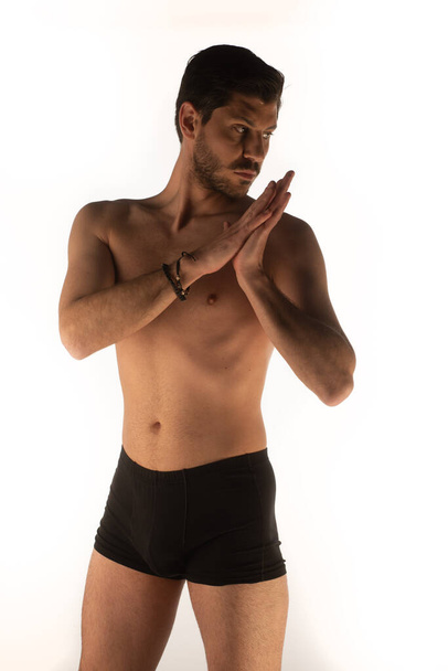 Handsome man in underwear making sensual poses and touching himself in the studio - Zdjęcie, obraz