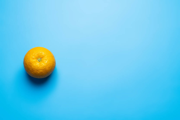 Πάνω όψη του πορτοκαλί σε μπλε φόντο - Φωτογραφία, εικόνα