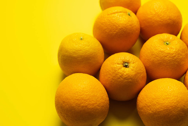 Top view of oranges in peel on yellow background  - Photo, image