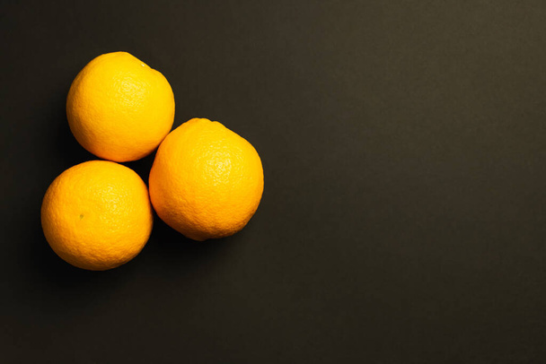 Top view of sweet oranges isolated on black  - 写真・画像