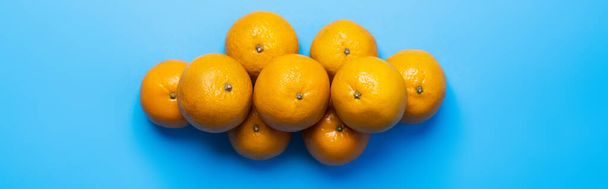 Top view of tangerines on blue background, banner  - Foto, imagen