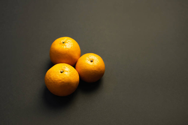 High angle view of tasty tangerines on black background - Foto, afbeelding