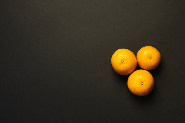 Top view of fresh tangerines isolated on black with copy space - Fotó, kép