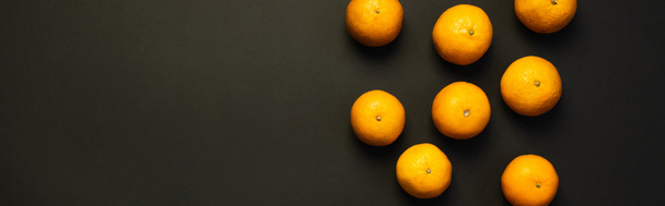 Top view of natural bright tangerines on black background, banner  - Fotoğraf, Görsel