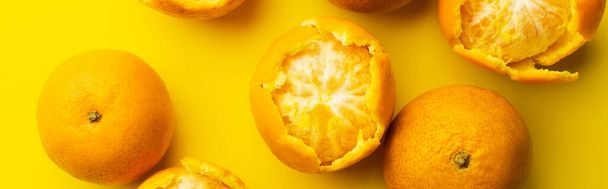 Top view of sweet tangerines in peel on yellow background, banner  - Fotoğraf, Görsel