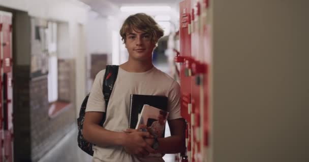 4k video footage of a teenage boy standing next to his locker at high school. - Séquence, vidéo