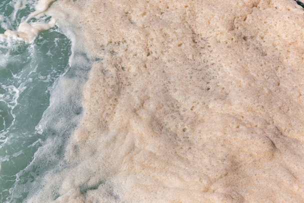 Ocean sea water foam from large waves crashing breaking wash and currents overhead close up photograph. - Foto, Imagem