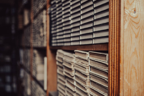 Old books on dark shelves - Foto, imagen